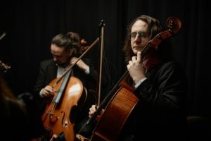 Devoted Cellists Performing Symphony in Chamber Ensemble